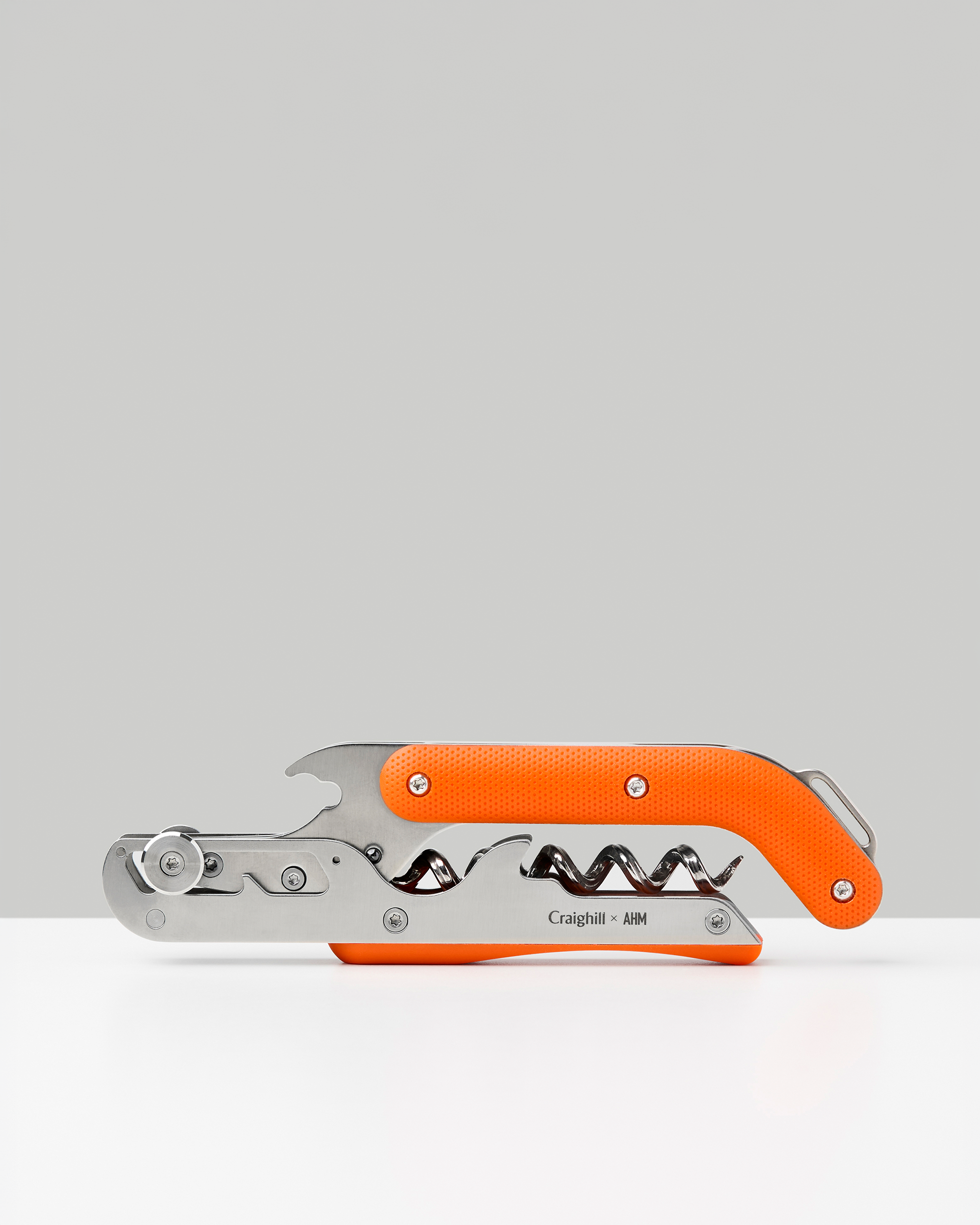 Craighill Best Wine Key in orange and stainless steel, folded closed against a gray background.
