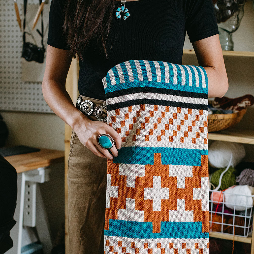 Seek & Swoon Desert Dweller Throw. Turquoise and ochre geometry designed with Native knitwear artist Jennifer Berg.